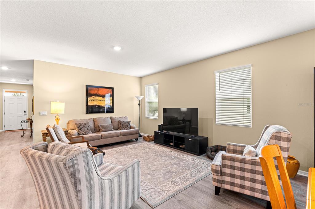 6365 Southwest 88th Loop Ocala, FL 34476 - Photo 9 of 35 a living room with furniture and a flat screen tv