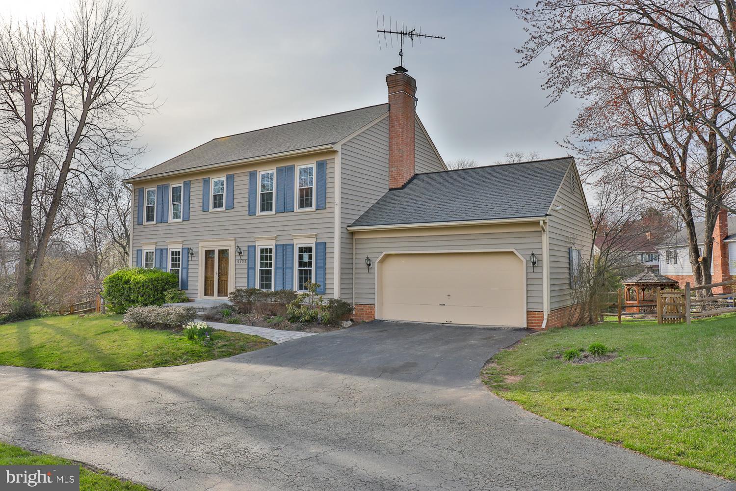 5423 Rilian Court Burke, VA 22015 - Photo 6 of 67 a front view of a house with a garden and garage