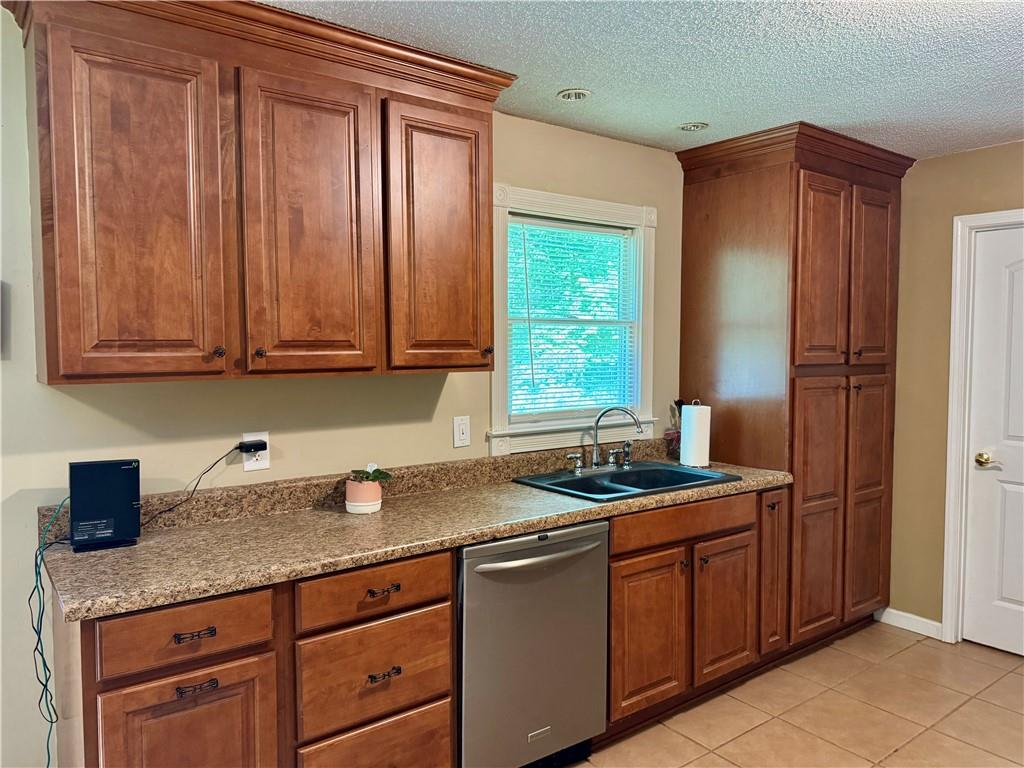 94 Big Jim Road Cleveland, GA 30528 - Photo 14 of 25 a kitchen with stainless steel appliances granite countertop wooden cabinets a sink and a window