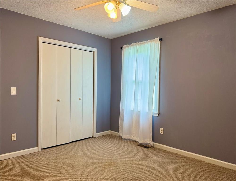 94 Big Jim Road Cleveland, GA 30528 - Photo 19 of 25 an empty room that has a window and a fan