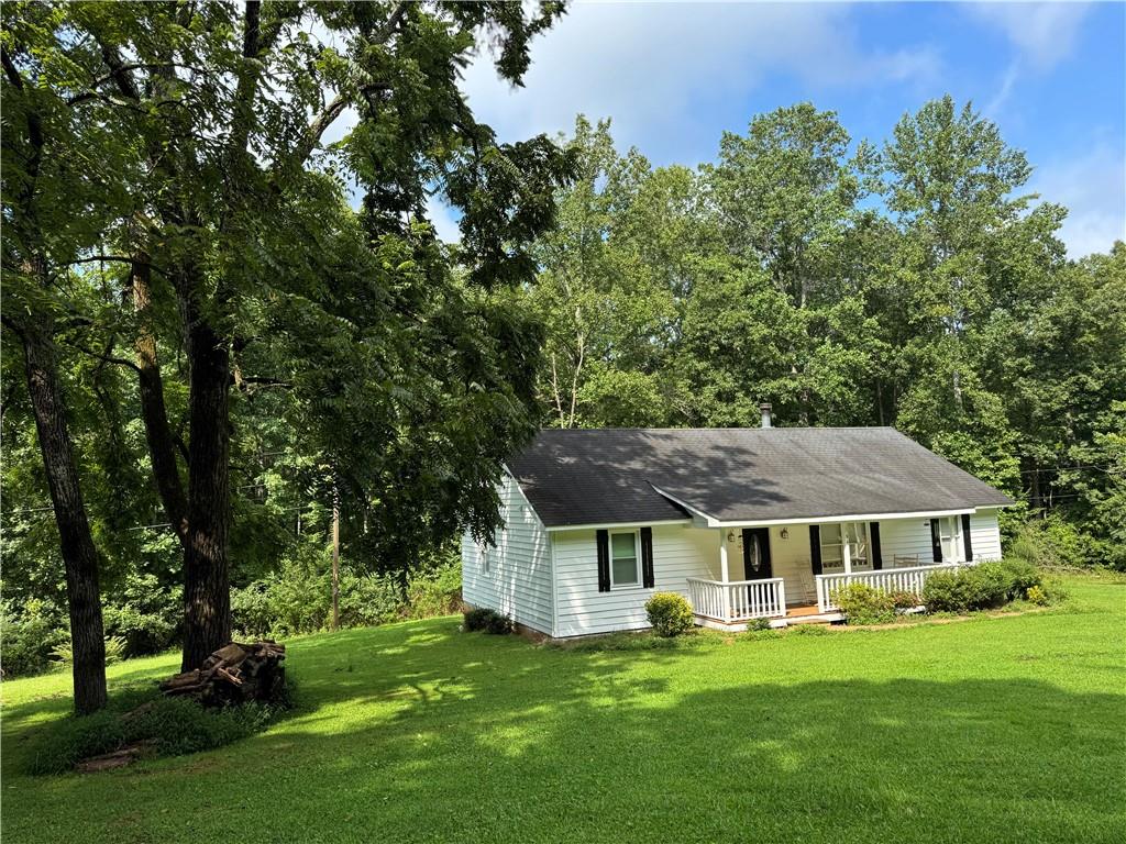 94 Big Jim Road Cleveland, GA 30528 - Photo 4 of 25 a front view of a house with a garden