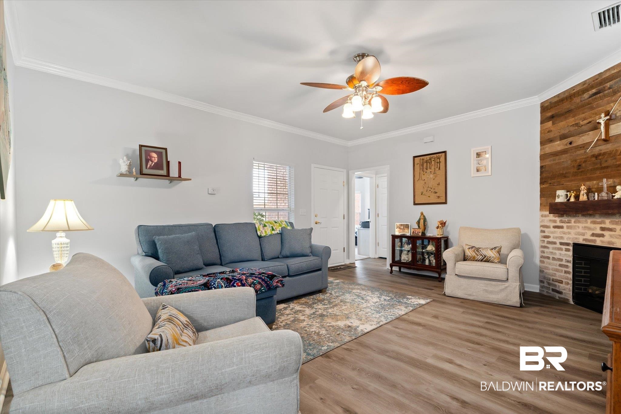 3876 Emerille Drive Foley, AL 36535 - Photo 4 of 31 Living room with hardwood / wood-style floors, ceiling fan, a fireplace, and crown molding