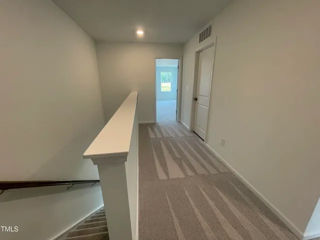 a view of a hallway with staircase