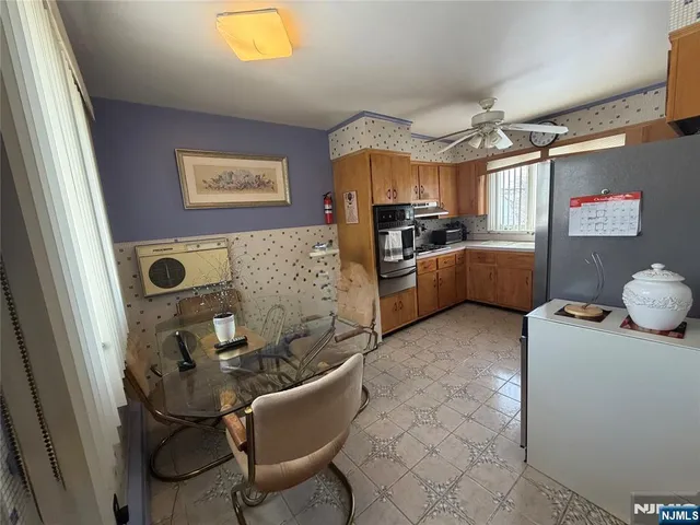 a kitchen with stainless steel appliances a refrigerator sink and cabinets