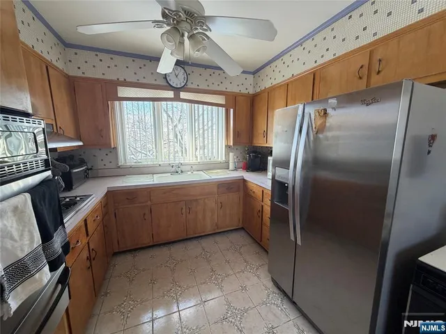 a kitchen with a refrigerator and a sink