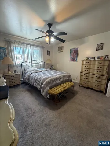 a bed room with a bed and a ceiling fan