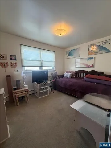 a living room with furniture a bed and a window