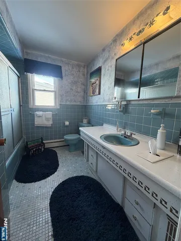 a kitchen with stainless steel appliances granite countertop a sink a stove and a wooden floors