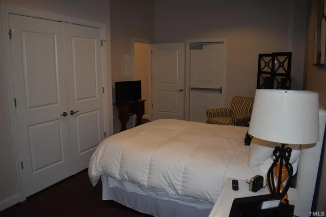 a bedroom with a bed and a lamp