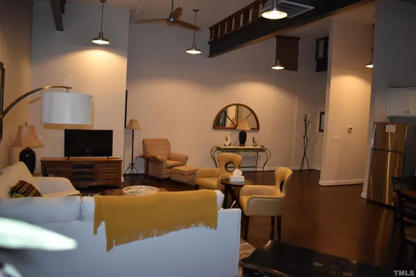 a living room with furniture a flat screen tv and a fireplace