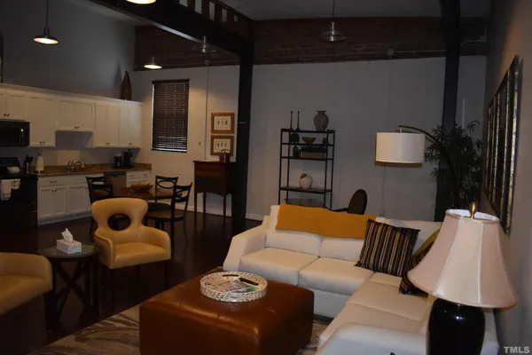 a living room with furniture and a lamp