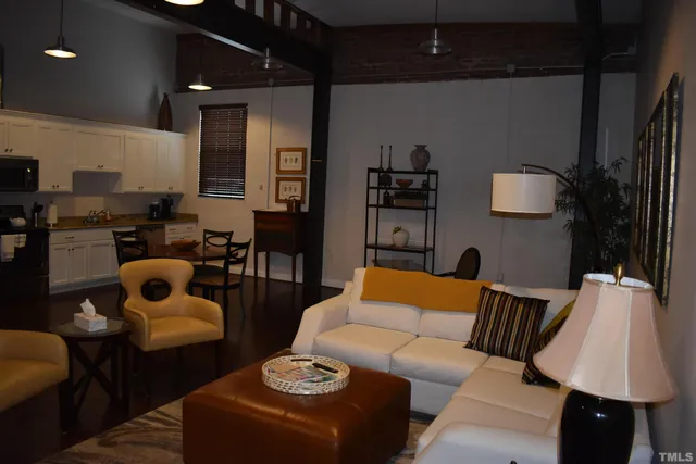 a living room with furniture and a lamp