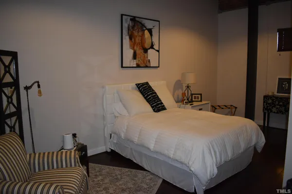 a bedroom with a bed and a night stand