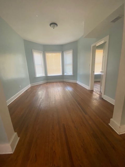 3907 West Monroe Street Chicago, IL 60624 - Photo 11 of 14 a view of an empty room with wooden floor and window