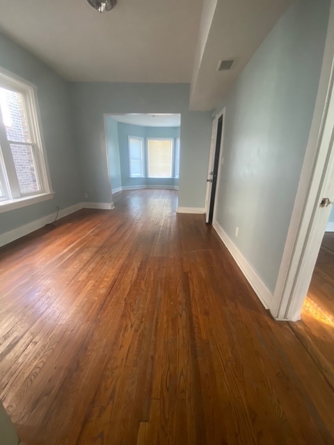 3907 West Monroe Street Chicago, IL 60624 - Photo 12 of 14 wooden floor in an empty room with a window