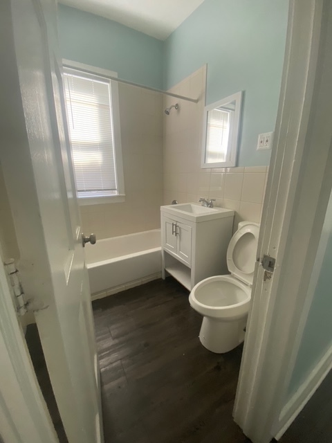 3907 West Monroe Street Chicago, IL 60624 - Photo 13 of 14 a bathroom with a toilet sink and mirror