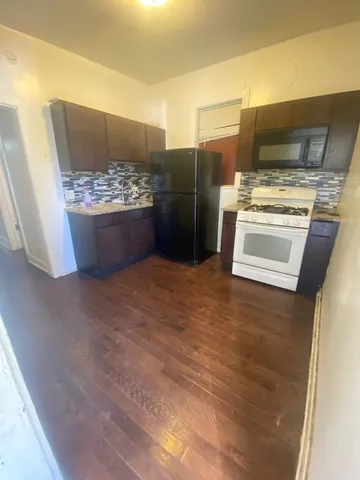 a kitchen with stainless steel appliances a refrigerator and a stove
