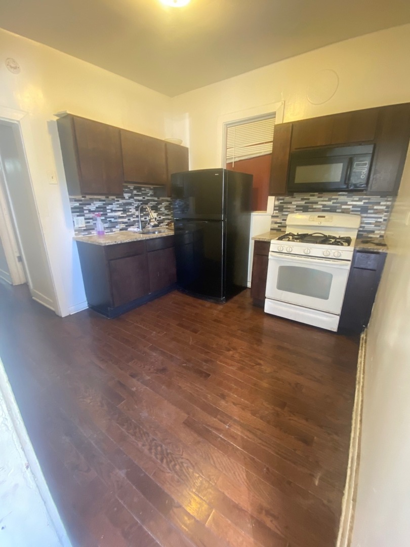 3907 West Monroe Street Chicago, IL 60624 - Photo 6 of 14 a kitchen with stainless steel appliances a refrigerator and a stove