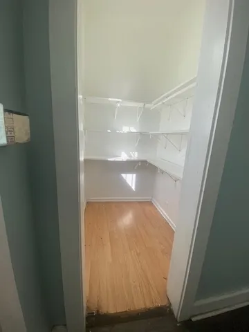 a view of a room with wooden floor