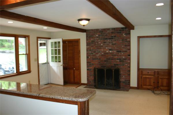 7 Brown Road Harvard, MA 01451 - Photo 3 of 22 a view of an empty room with a fireplace and a window