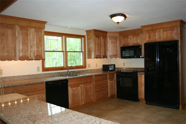 7 Brown Road Harvard, MA 01451 - Photo 9 of 22 a kitchen with stainless steel appliances granite countertop a stove a sink and a microwave