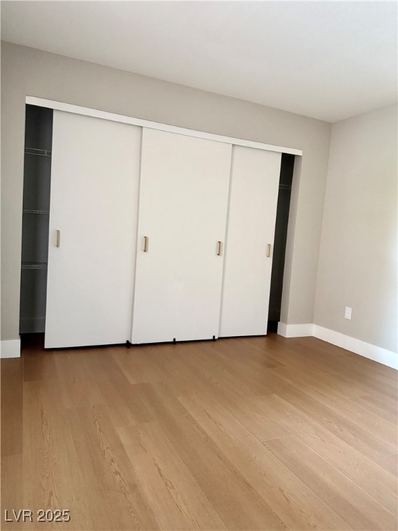 1150 North Buffalo Drive, Unit 2025 Las Vegas, NV 89128 - Photo 6 of 20 Unfurnished bedroom with light wood finished floors and baseboards