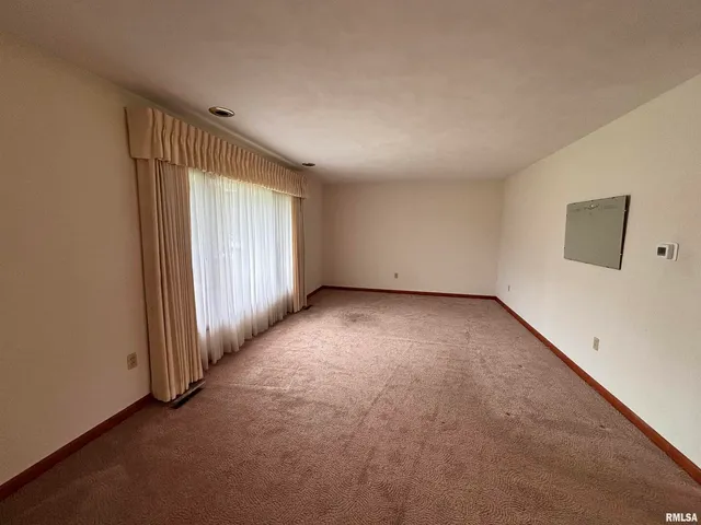 an empty room with a empty space and windows