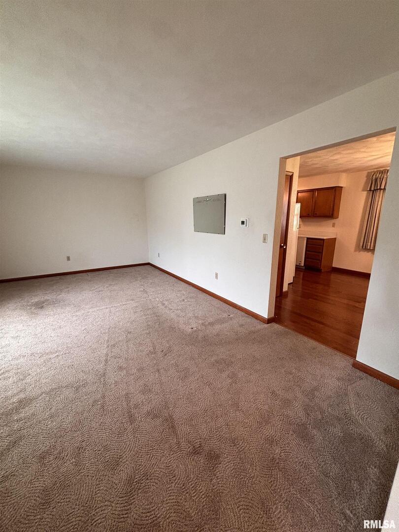 630 Mission Drive Kewanee, IL 61443 - Photo 17 of 57 an empty room with wooden floor and a ceiling fan