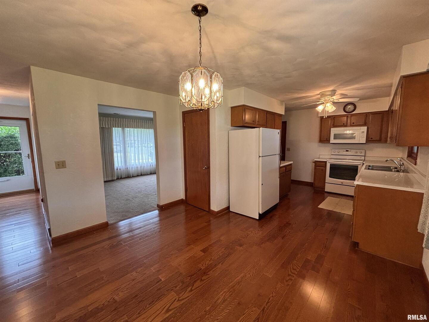 630 Mission Drive Kewanee, IL 61443 - Photo 19 of 57 a view of a livingroom with hardwood floor and a kitchen