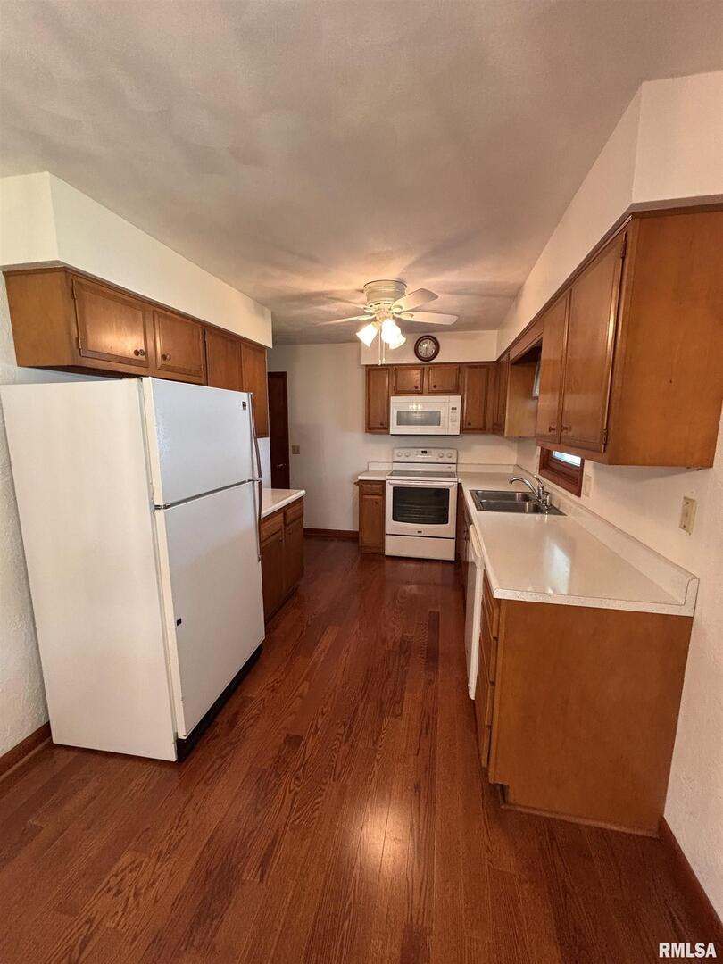 630 Mission Drive Kewanee, IL 61443 - Photo 24 of 57 a open kitchen with wooden floor and a refrigerator