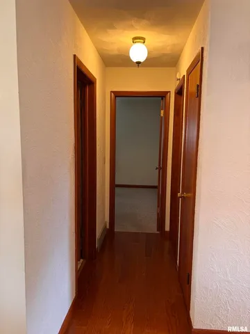 an empty room with large window and door