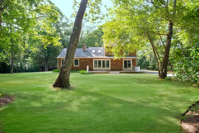 a house view with a play ground in front of it