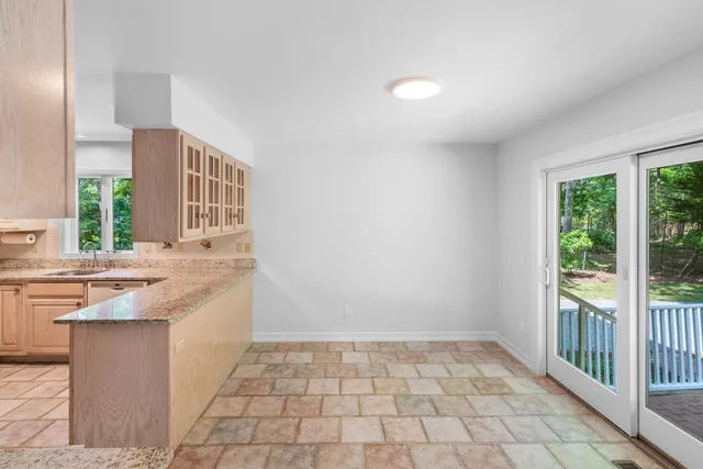 a kitchen with granite countertop a sink and a stove