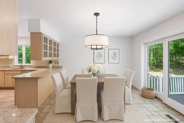 a dining room with furniture a chandelier and wooden floor