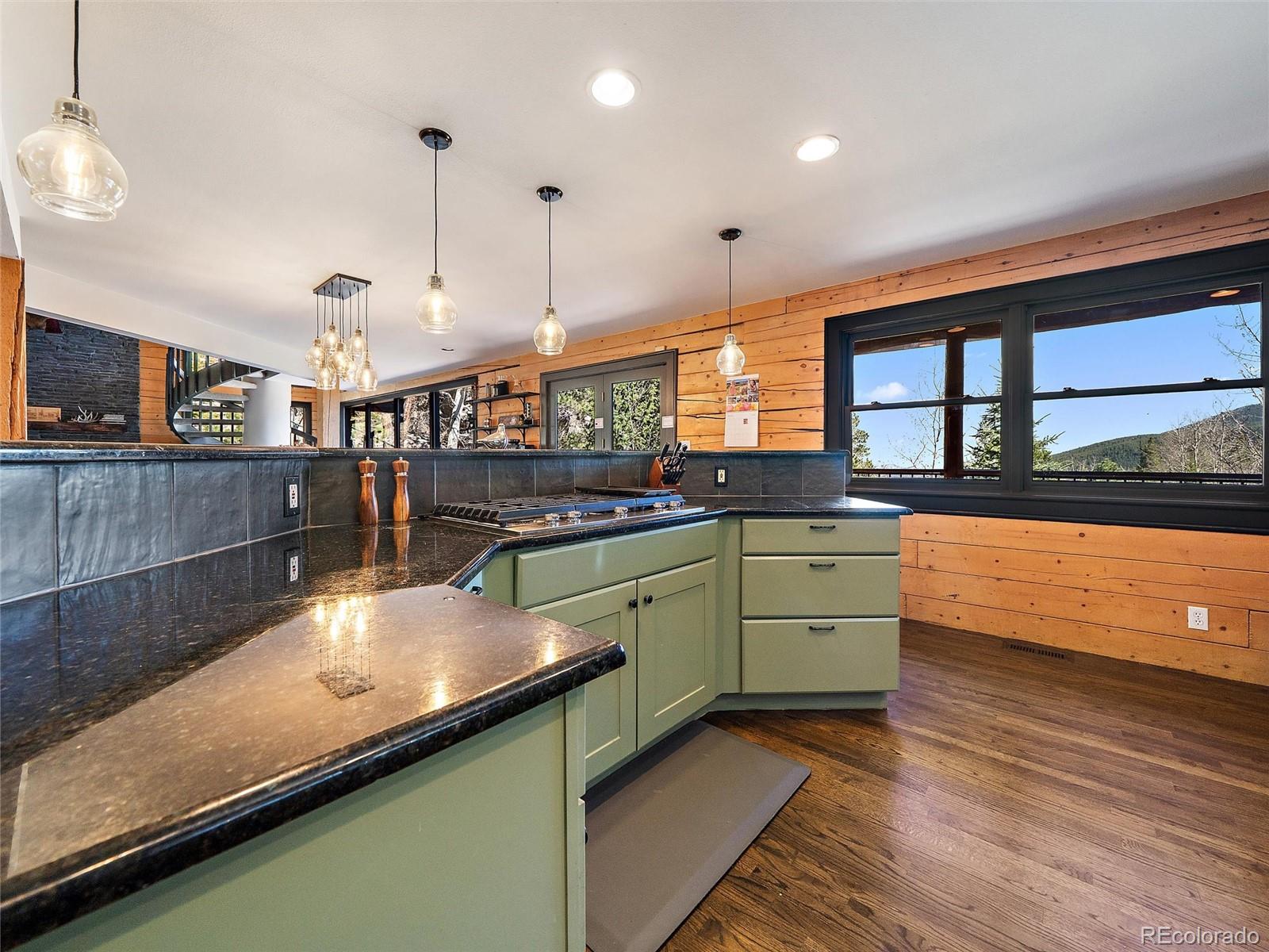 24 Pine Valley Road Evergreen, CO 80439 - Photo 8 of 50 a kitchen with stainless steel appliances granite countertop a sink and a stove