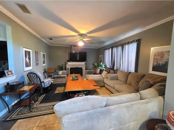 a living room with furniture a fireplace and a flat screen tv