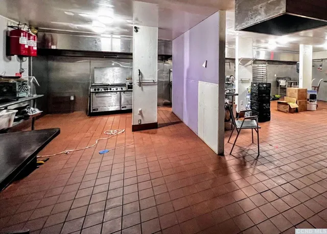 a view of a livingroom with furniture and a kitchen