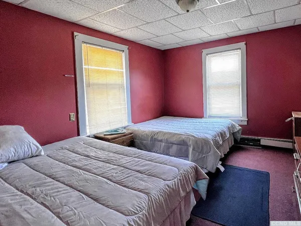 a bedroom with bed and a window