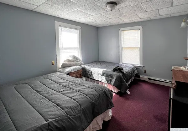 a bedroom with two beds and a window