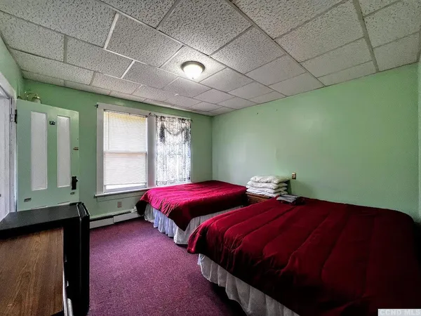 a bedroom with bed and window
