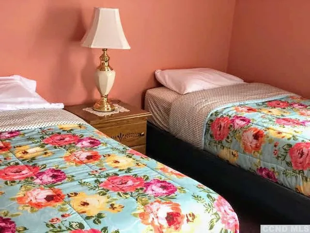a bedroom with bed and a dresser
