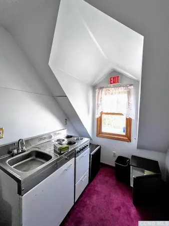 a kitchen that has a sink and a stove