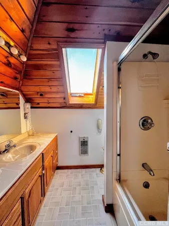 a bathroom with a tub and a sink