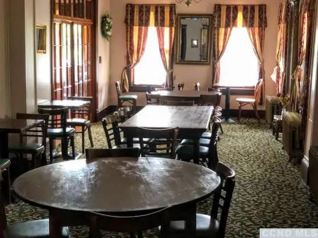 a dining table with chairs and window