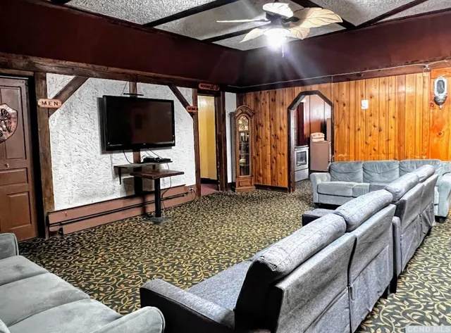 a living room with furniture and a flat screen tv