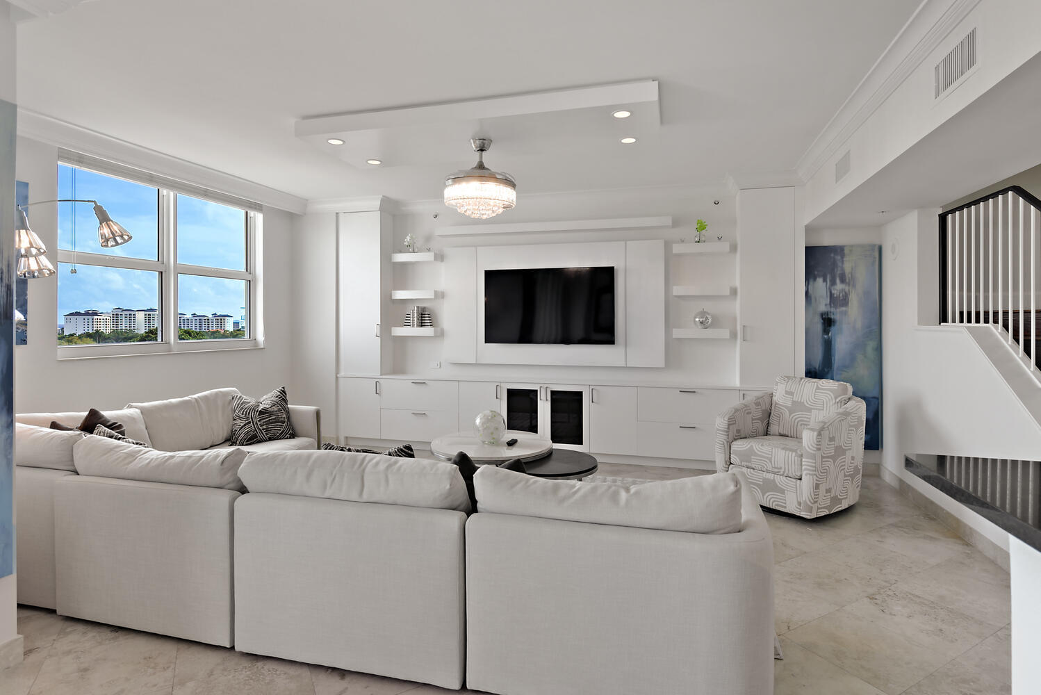 99 Southeast Mizner Boulevard, Unit PH 909 Boca Raton, FL 33432 - Photo 11 of 51 a living room with furniture and a flat screen tv