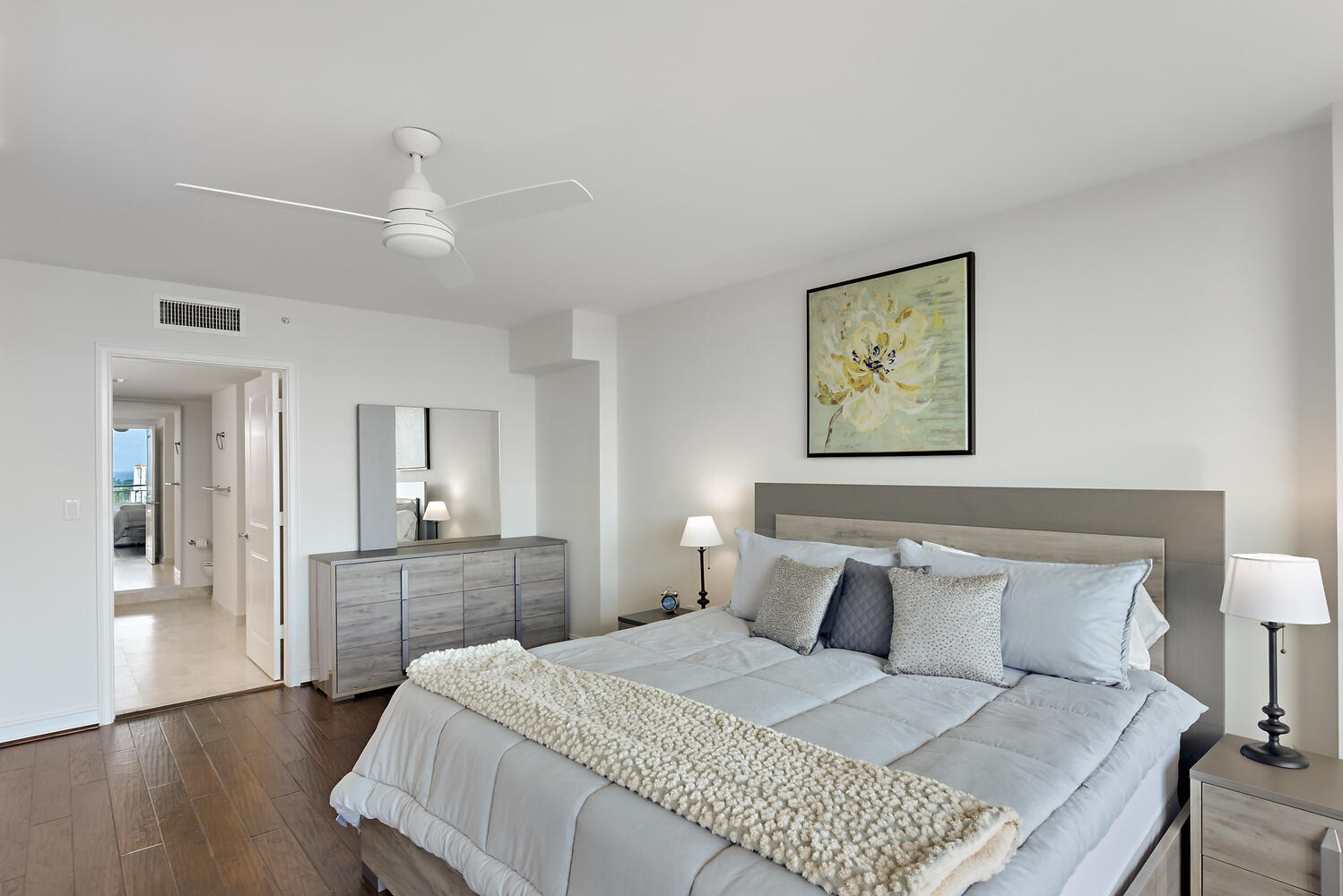 99 Southeast Mizner Boulevard, Unit PH 909 Boca Raton, FL 33432 - Photo 17 of 51 a bedroom with bed and wooden floor