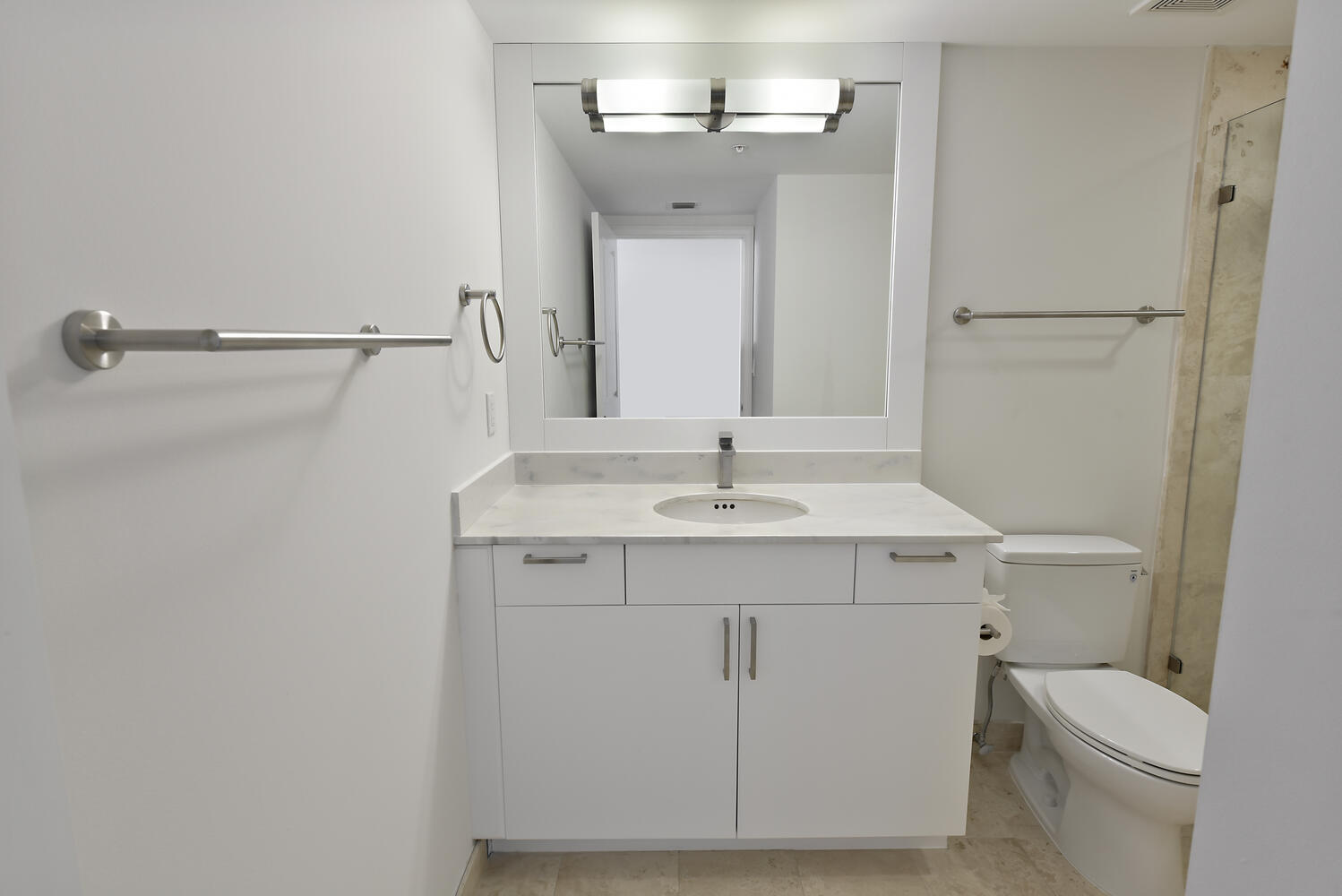 99 Southeast Mizner Boulevard, Unit PH 909 Boca Raton, FL 33432 - Photo 21 of 51 a bathroom with a sink a toilet and mirror
