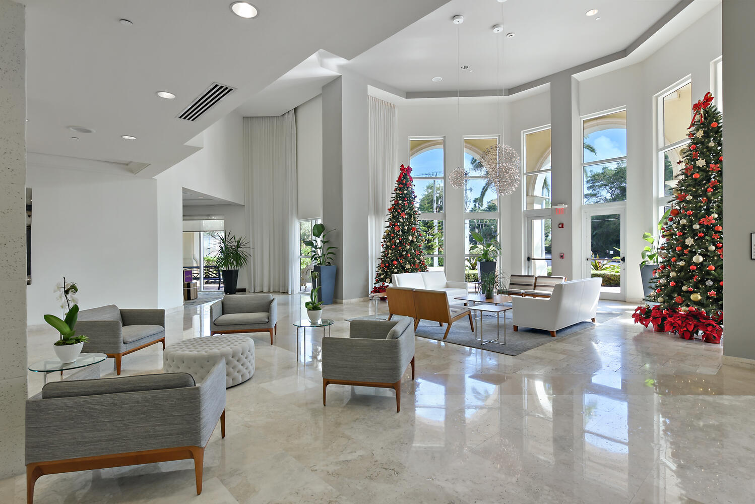 99 Southeast Mizner Boulevard, Unit PH 909 Boca Raton, FL 33432 - Photo 34 of 51 a living room with furniture and a potted plant