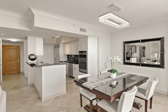 a living room with furniture a dining table and kitchen view